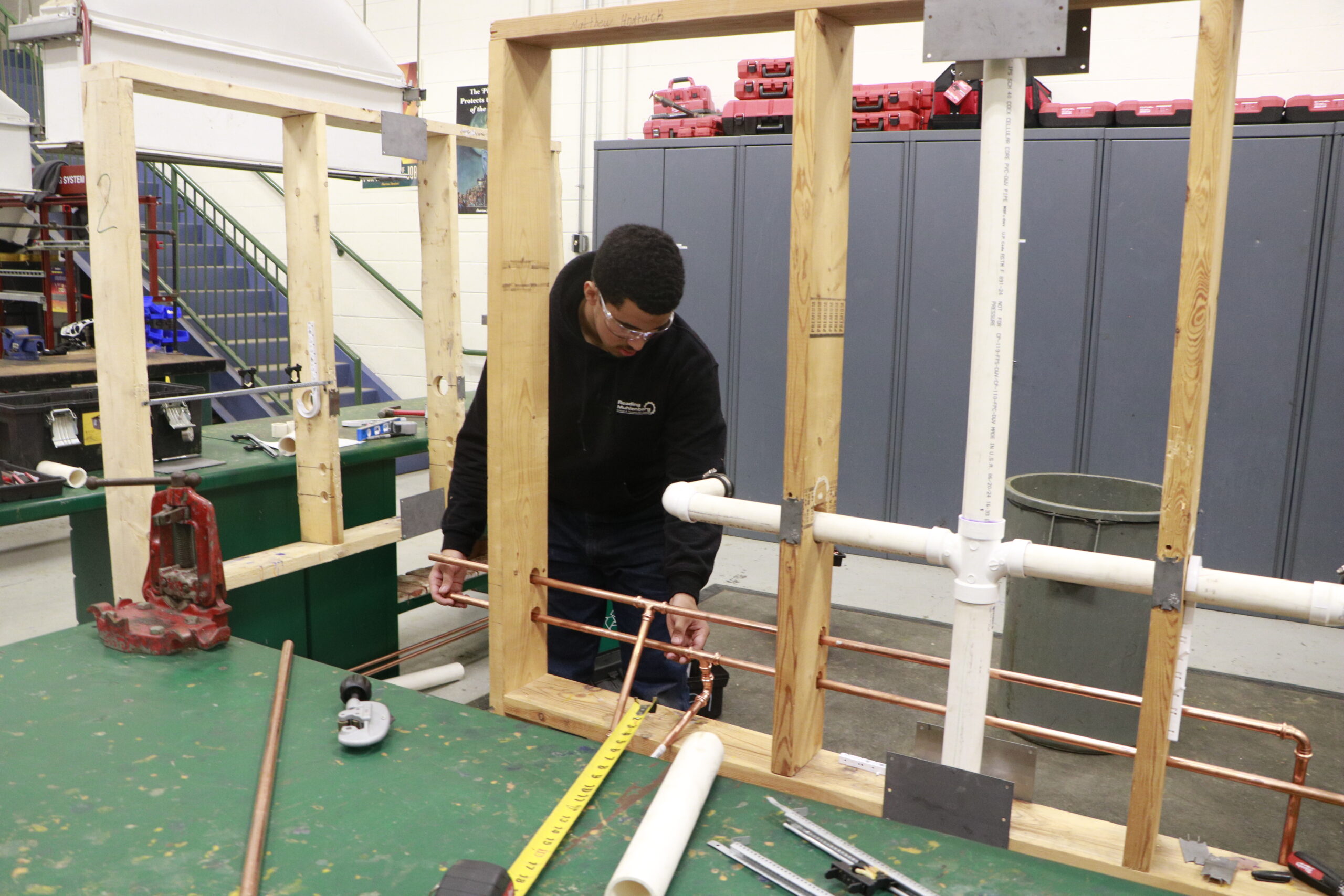 Student setting up pipes