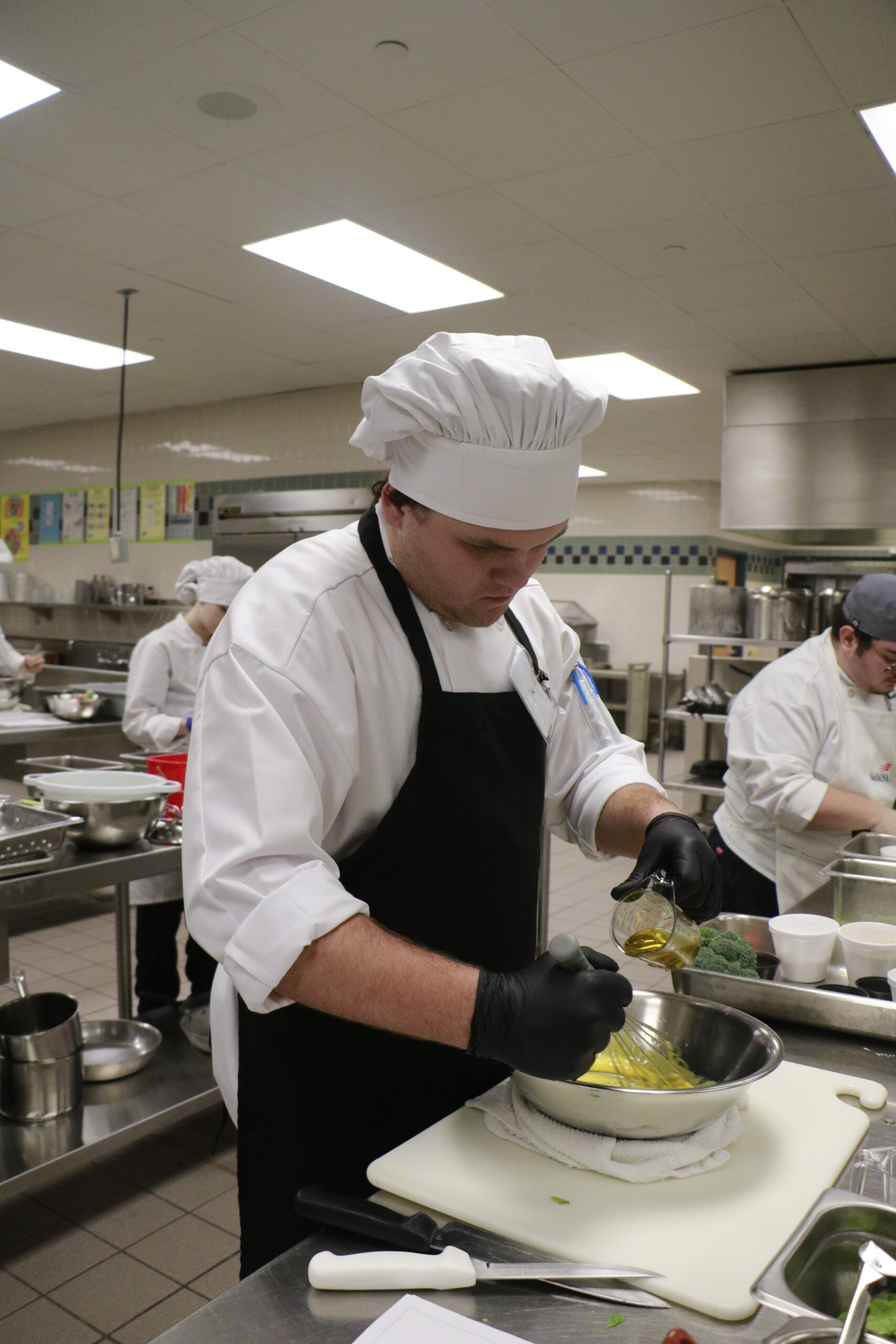 Student mixing ingredients in bowl