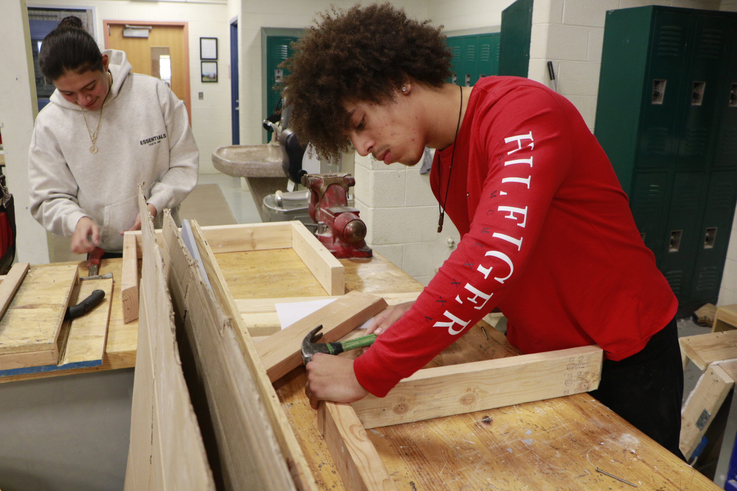 Student hammering nails into wood